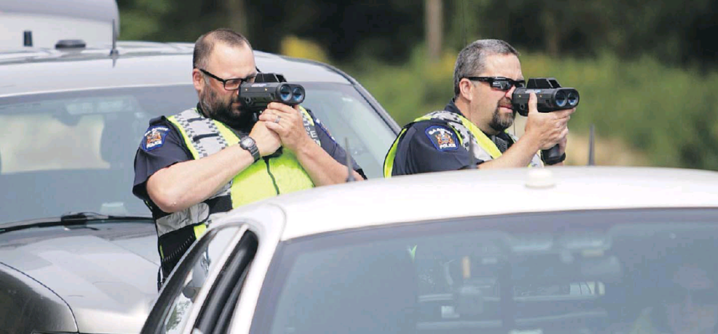 Saanich police constables Drew Hildred, left, and Kevin Bates use radar at a speed-trap operation on Shawnigan Lake Road. Columnist Steve Wallace writes that speed enforcement in Canada tends to be stationary, while U.S. enforcement is often from moving vehicles.